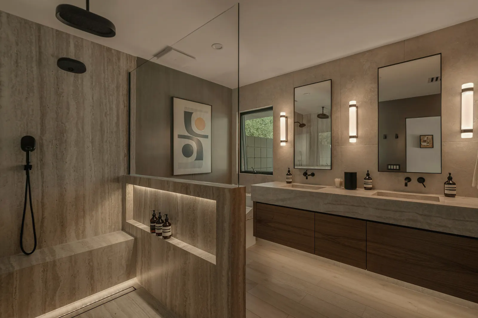 A double vanity with floating cabinets and stone walls