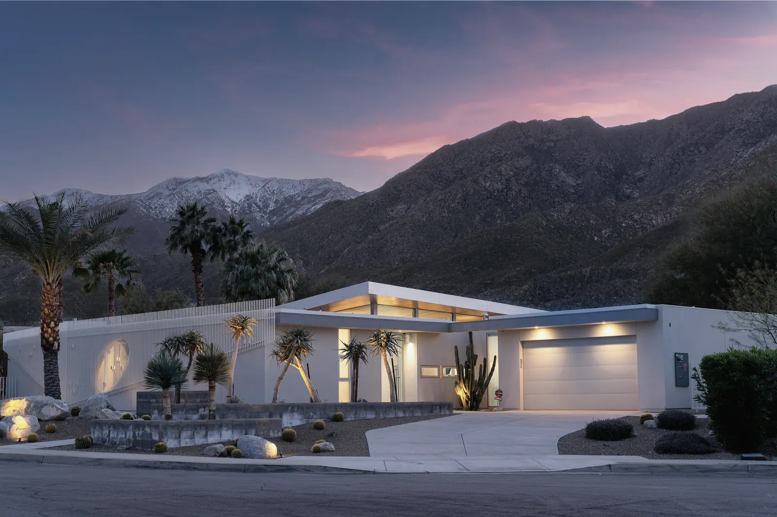 A desert-modern home under a pink evening sky