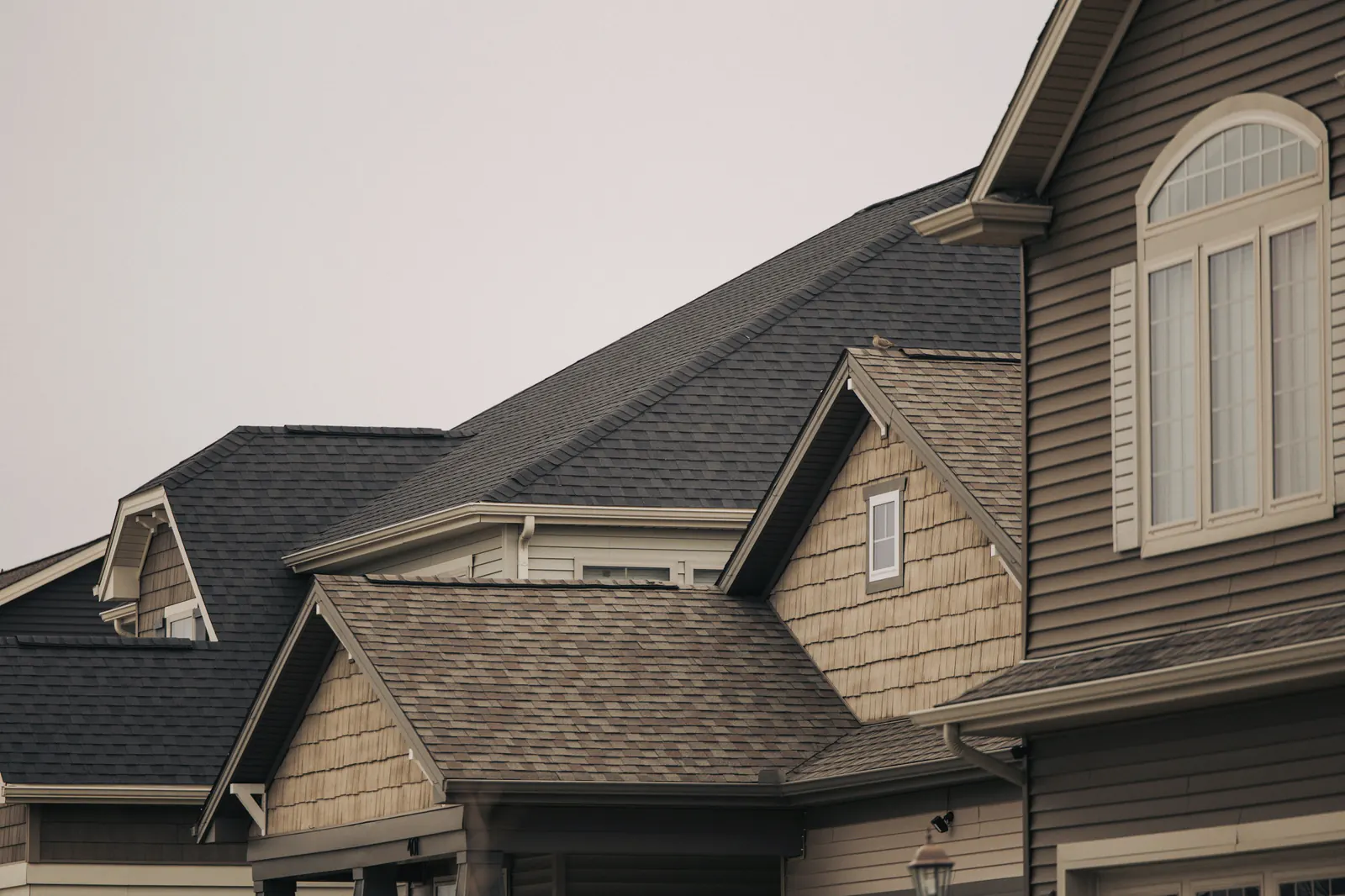 Pitched shingle roofs on a row of Arizona homes